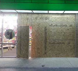 a shop with windows boarded up